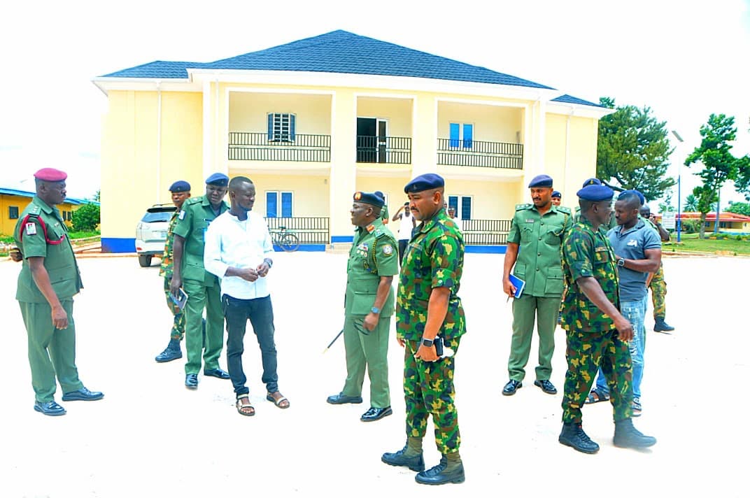 Walk-through with the client. Army officers and the project team in front of the completed block.