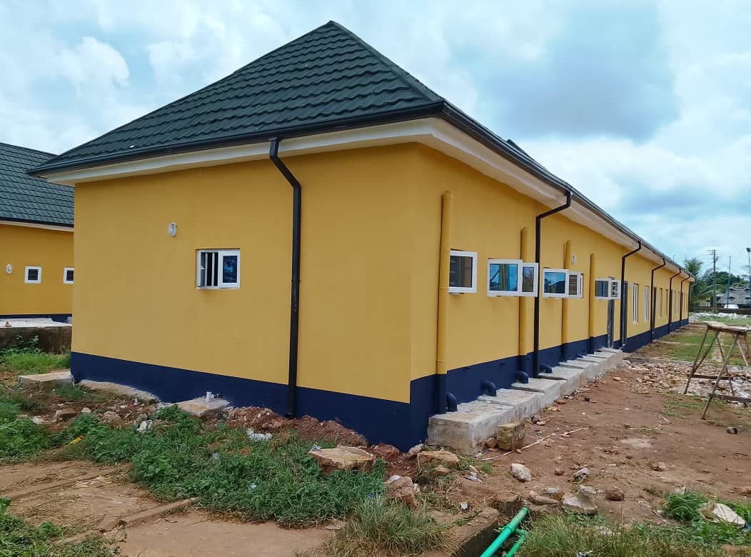 Block corner and roof line. Deep eaves, rainwater goods and a clean plinth detail along the block.