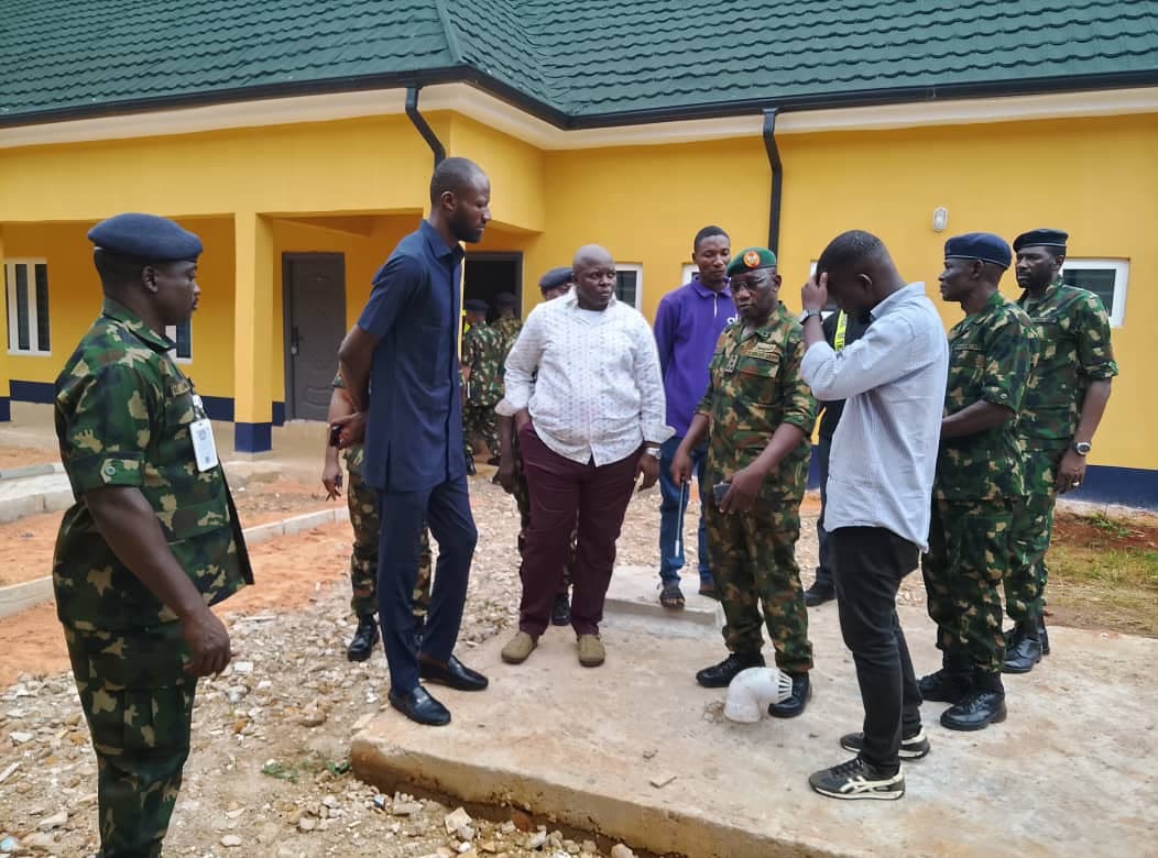 Client site inspection. Army personnel and the project team walking the completed blocks.