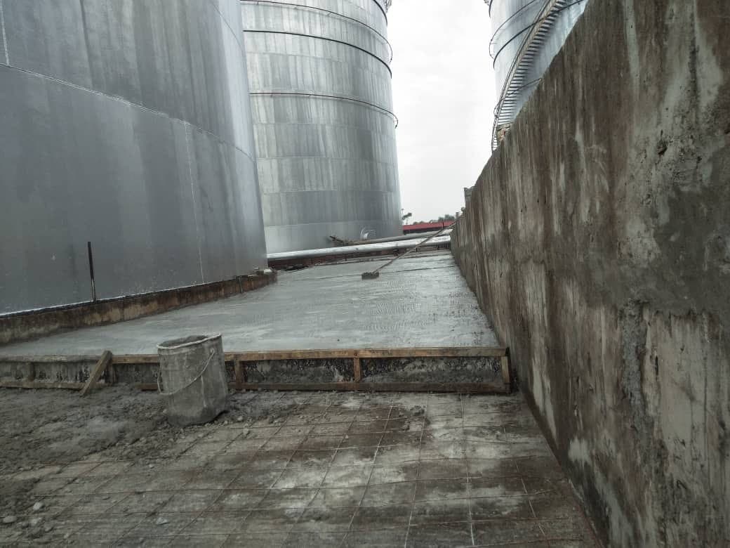 Freshly finished slab with reinforcement mesh exposed at the edge.